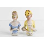 Two antique German porcelain tea cosy dolls, 8.5cm high.