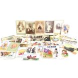A group of vintage comical postcards and antique photographs,