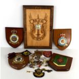 A group of military badges, buttons and plaques to include T.R.F.A Gloster badge, Royal Canadian