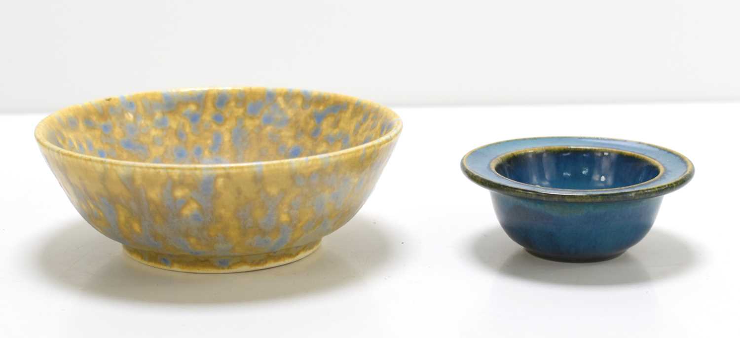 A small Ruskin bowl with yellow underglaze and mottled blue overglaze indistinctly dated 1927 and