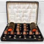 A Royal Worcester cased set of twelve coffee cans and saucers, with solid silver gilt holders and