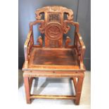 A Chinese carved temple chair, the shaped back having decoratively pierced panels and a central