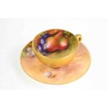 A Royal Worcester miniature cup and saucer, painted wiht fruit on a mossy ground, gilded exterior,