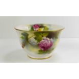 A small Royal Worcester fruit bowl, painted with roses to the outside, gilt rim to the top and