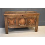 A 17th century oak coffer, the three panel lid above run moulded rails, raised on sile legs, 72cm