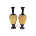 A pair of Doulton Lambeth vases of slim baluster form, the bodies with impressed decoration with