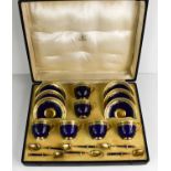 A set of Royal Worcester coffee cups and saucers, with gilded enamel spoons by Mappin & Webb, cobalt