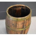 A 19th century coopered oak barrel with brass bands, 62cm high.This lot is not part of the Hooper