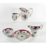 A New Hall pottery clip handle cream jug, tea bowl and saucer decorated in purple borders with