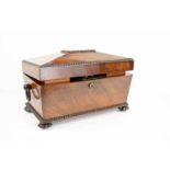 A 19th century mahogany sarcophagus form tea caddy, with the original interior boxes, glass bowl and