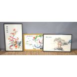 A group of three framed Chinese silk embroidered panels depicting birds and landscape scenes.