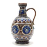Bessie J Youatt for Doulton Lambeth: A stoneware jug decorated with incised abstract floral