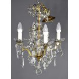 A French 1930's glass and gilt metal four branch chandelier, later refurbished the central column