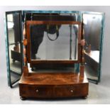 A 19th century bow fronted mahogany toilet mirror, the vertical supports terminating in