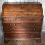 A Georgian mahogany bureau, with two over three graduated drawers, the fall front revealing a fitted