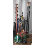 A group of hand tools and other items to include spades, forks, sledgehammers, axe, leaf blower,
