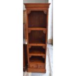 A tall hardwood Indonesian style bookcase with three shelves and two lower drawers, 186cm high.