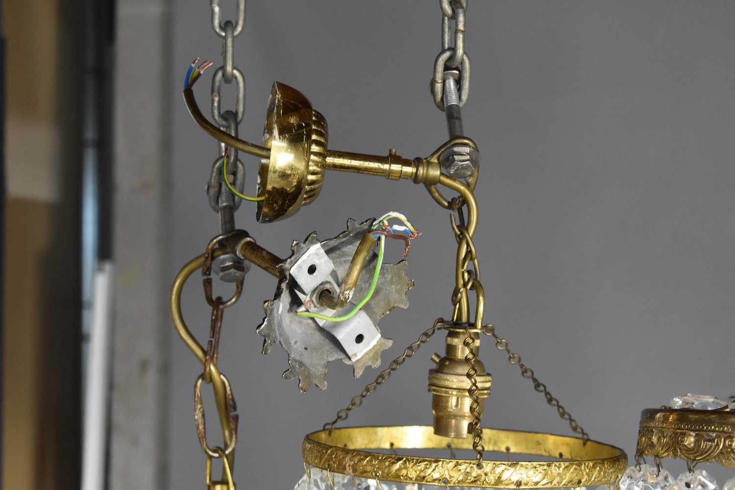 A group of three cut glass and gilt metal chandeliers, comprising one of bag form and two Empire - Image 4 of 4