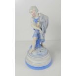 A 20th century bisque figurine of a boy, painted in blue hues, impressed to base with makers stamp