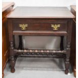 An 18th century oak side table with three plank top and single drawer, raised on turned legs