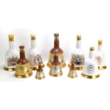 Ten Wade Bells Whisky bell form decanters with contents.