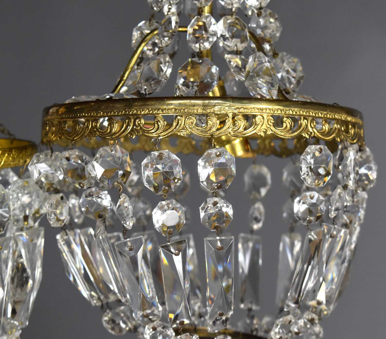 A group of three cut glass and gilt metal chandeliers, comprising one of bag form and two Empire - Image 3 of 4