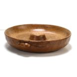 An early Robert "Mouseman" Thompson nut or pin bowl, with raised centre and carved mouse to the