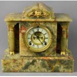 An early 20th century green agate mantle clock, with gilt metal dial flanked by columns.