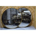 A pair of large circular mirrors, with bevelled glass to gilt frames, each 100cm diameter.