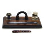 A vintage Conway Stewart 84 fountain pen with a 14ct gold nib together with an oak inkstand with two