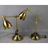 A pair of vintage style adjustable lamps, with brass sticks to swivel limbs and angle adjustable