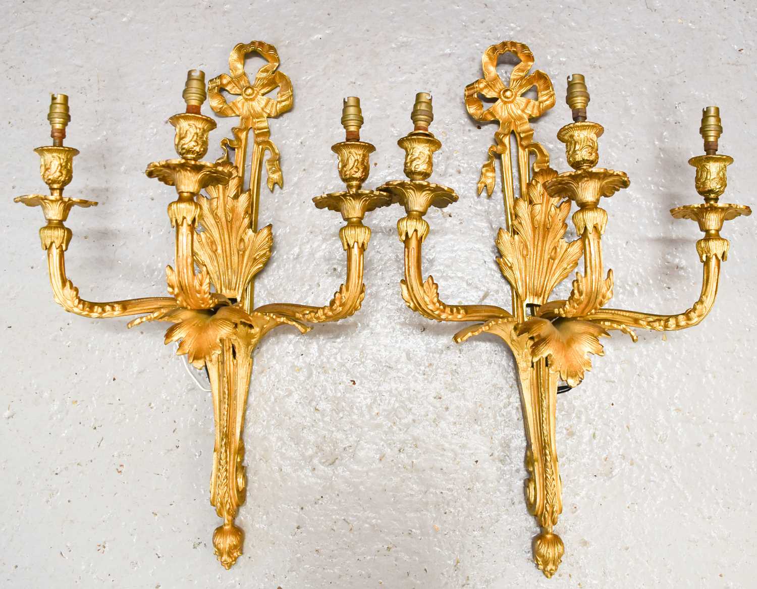 A pair of 19th century French gilt bronze wall sconces, with three branches raising 'candle'