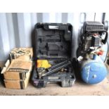 A Powercraft air compressor together with a Bostitch Magnesium nail gun and a quantity of nails.