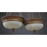 A pair of Empire style bronze painted ceiling lights, with opaque domed glass shades, together