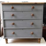 A painted antique pine chest of drawers, the two over three drawers raised on turned feet, 97cm