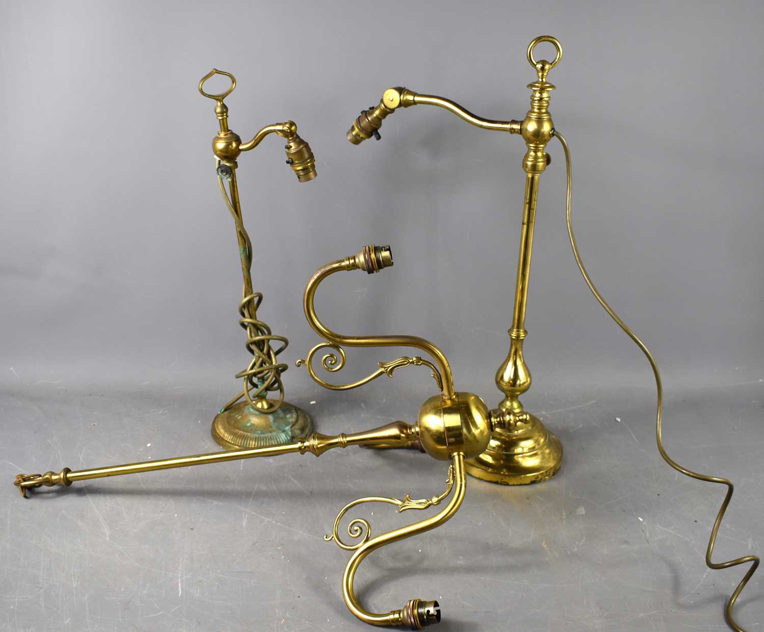 Two vintage adjustable brass table lamps, each having height adjustments to the stems, and angled