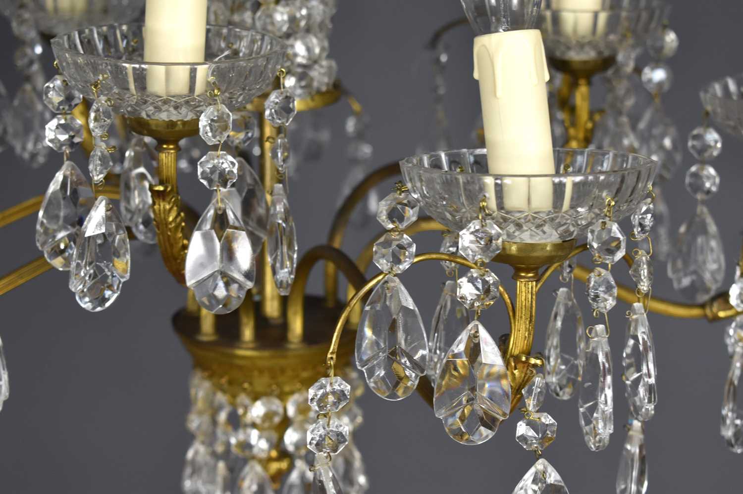 A glass and gilt metal nine branch chandelier, each of the scroll branches with three sprigs holding - Image 2 of 3