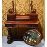 A Victorian mahogany dressing table, the top with shaped mirror, carved and pierced uprights, two