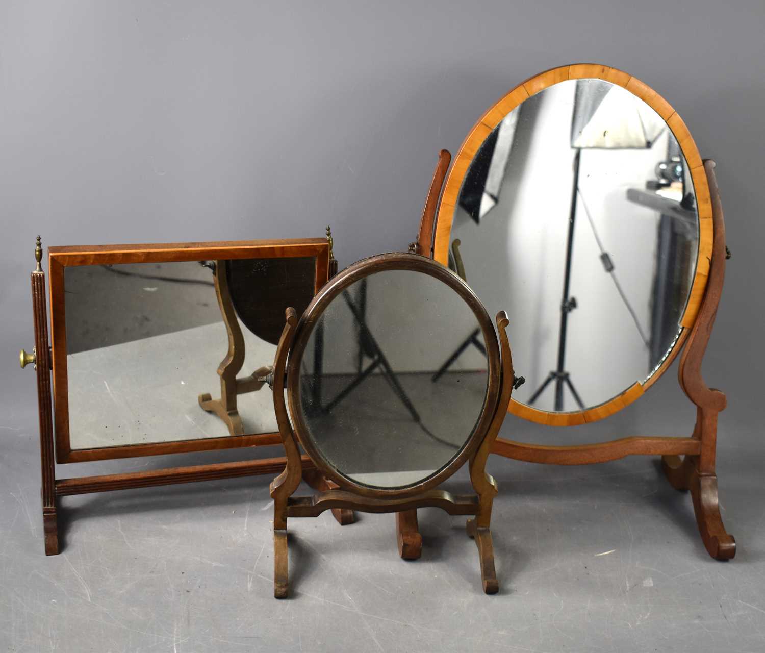 A group of three Victorian toilet mirrors, one of rectangular form with reeded columns and stretcher