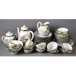 A Japanese tea set comprising teapot, cups, saucers, sugar bowl and plates, decorated with landscape