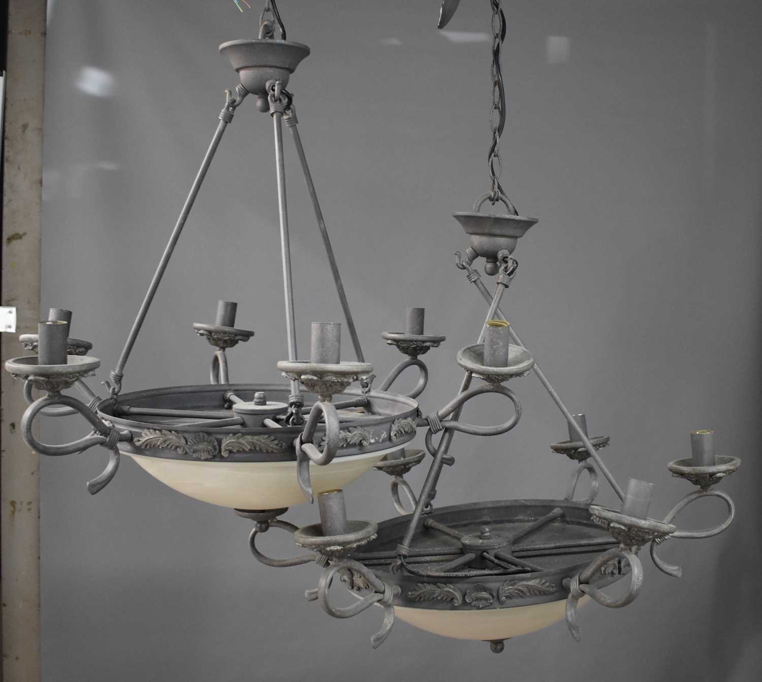 A pair of Empire style black painted metal ceiling lights, with opaque domed shades and six