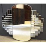 An Art Deco style wall mirror, with bevelled edges to each panel, 89 by 94cm.