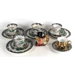 An early 20th century Crown Staffordshire part tea set, decorated with Chinese village scenes