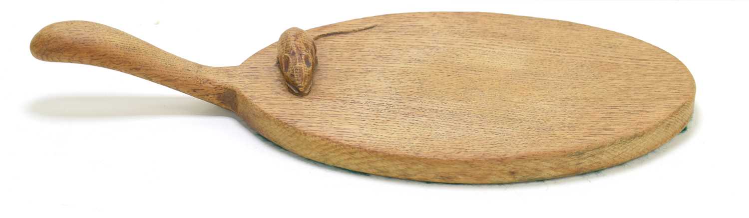 An early Robert "Mouseman" Thompson (1876-1955) oak cheese board, with carved mouse to the board.