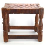 A Robert "Mouseman" Thompson oak stool with intertwined leather seat, with carved mouse to the