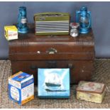 A vintage metal steamer trunk together with a pair of Boots binoculars, Roberts Radio, battery