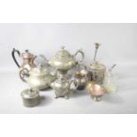 A group of silver plate and pewter, including a pedestal teapot, further teapots, a coffee pot,