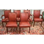 A set of six 20th century teak and red leather armchairs.