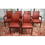 A set of six 20th century teak and red leather armchairs.