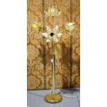 A brass and marbled glass standard lamp, modelled as four gaping flowers, on circular pedestal